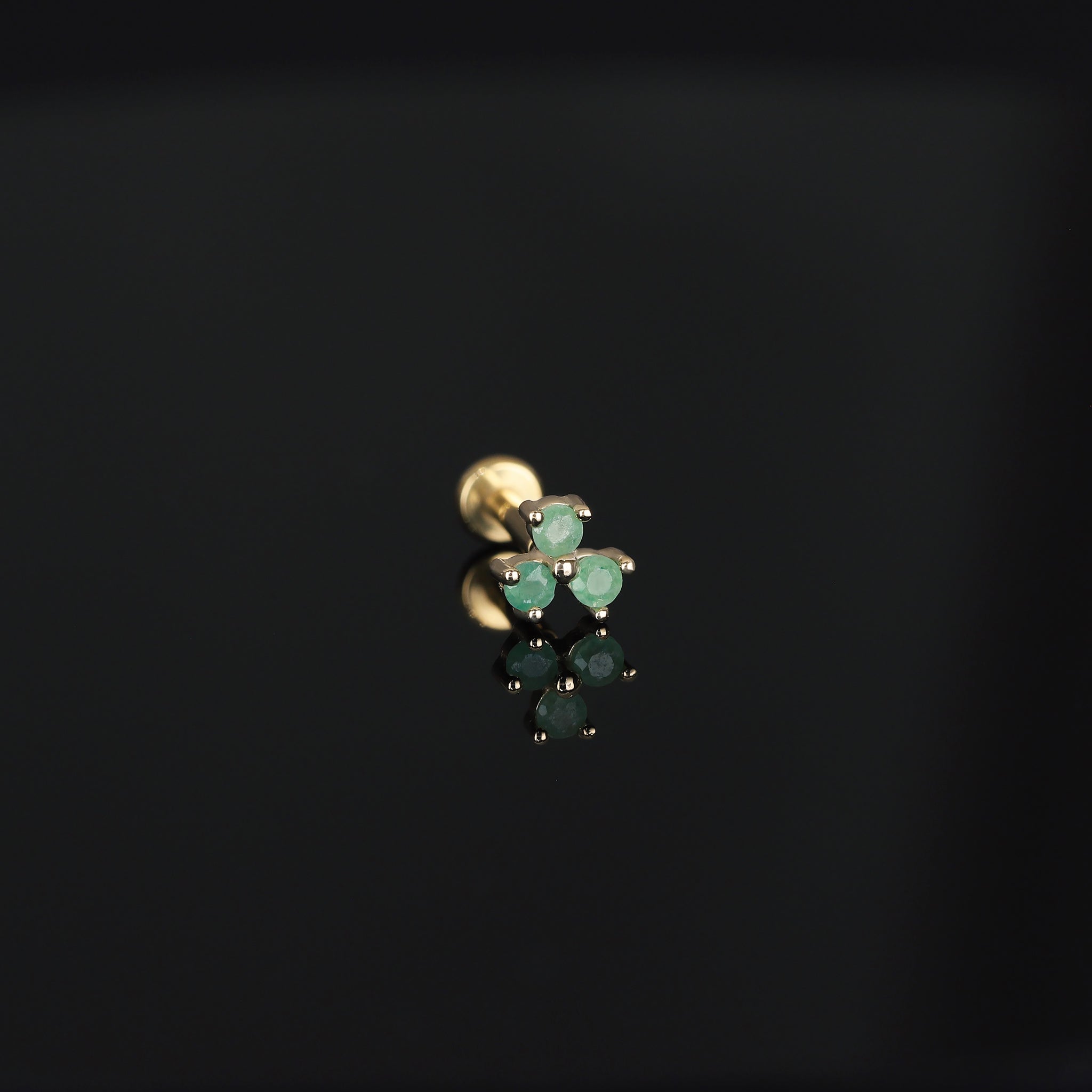 Threadless push pin, Ivy II, in Aventurine displayed on dark surface.