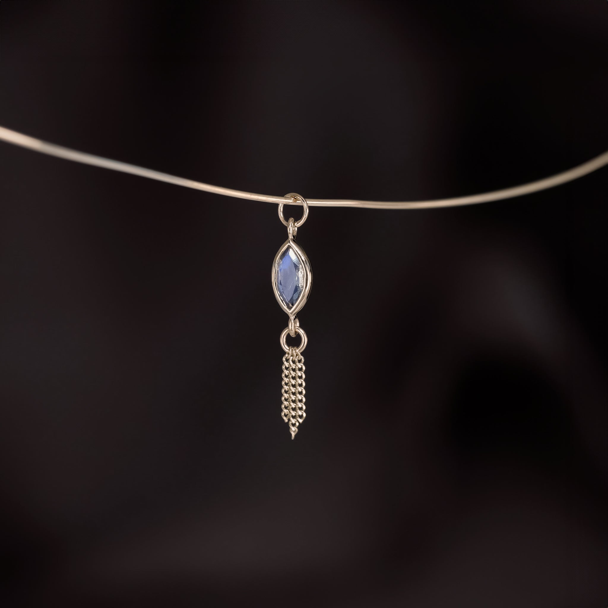 14K gold charm of a a marquise-cut Labradorite paired with three delicate gold curb chain tassels