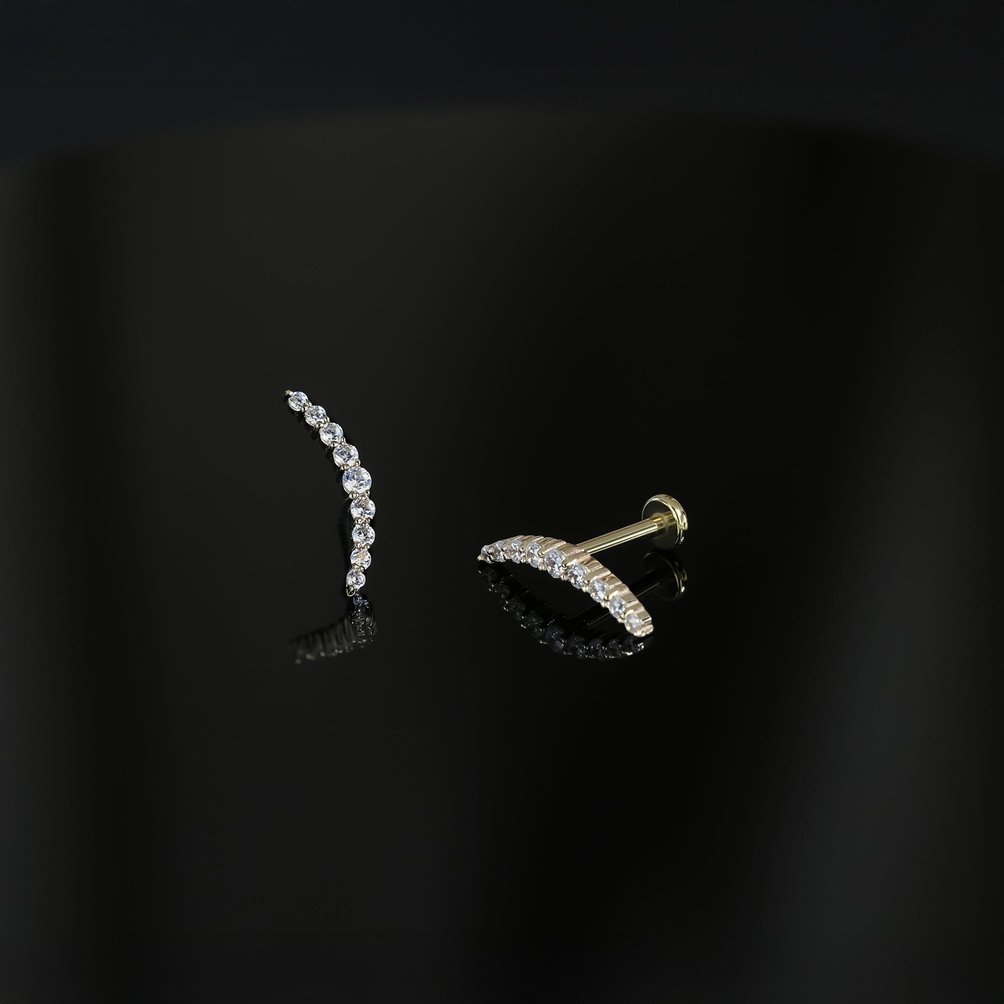 14K Gold Crescent Moon Cubic Zirconia studs in yellow gold displayed on a dark surface