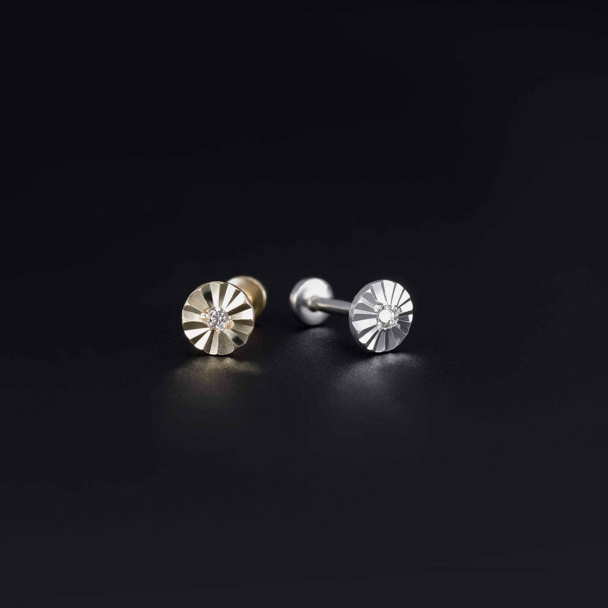 14k solid yellow gold and white gold flat disc studs with a diamond-cut pattern displayed on black background