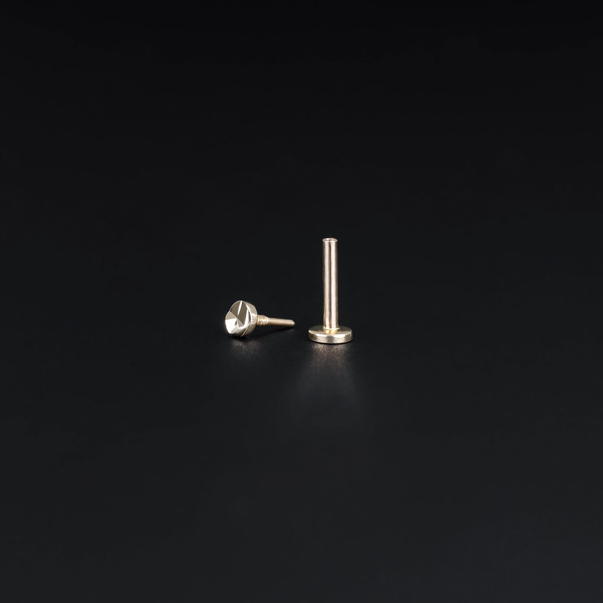 14K Solid Gold Diamond-Cut Tiny Disc 18G internally threaded stud and post end on black background