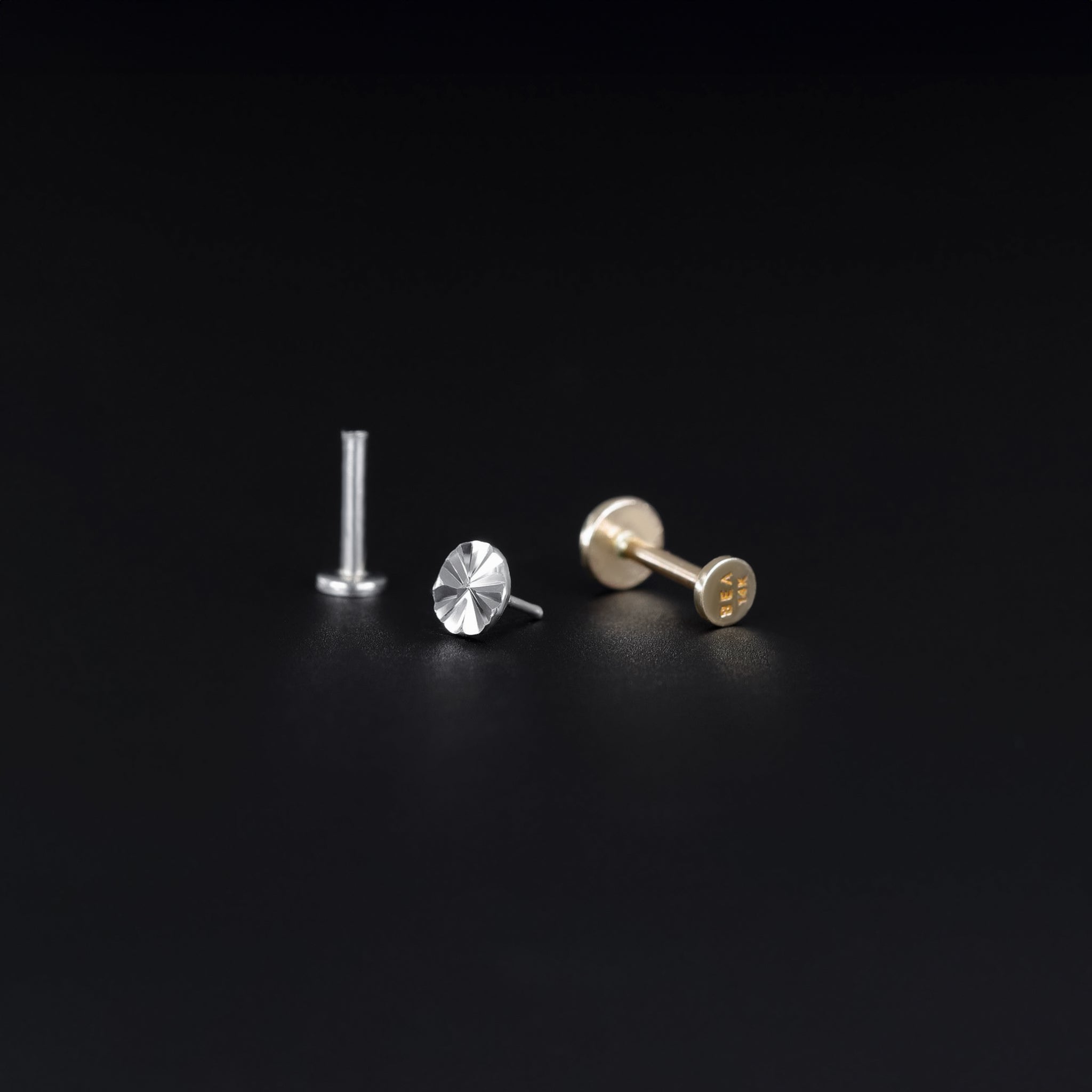 14K yellow and white gold studs with diamond-cut pattern on a flat round disc, 18G internally threaded design