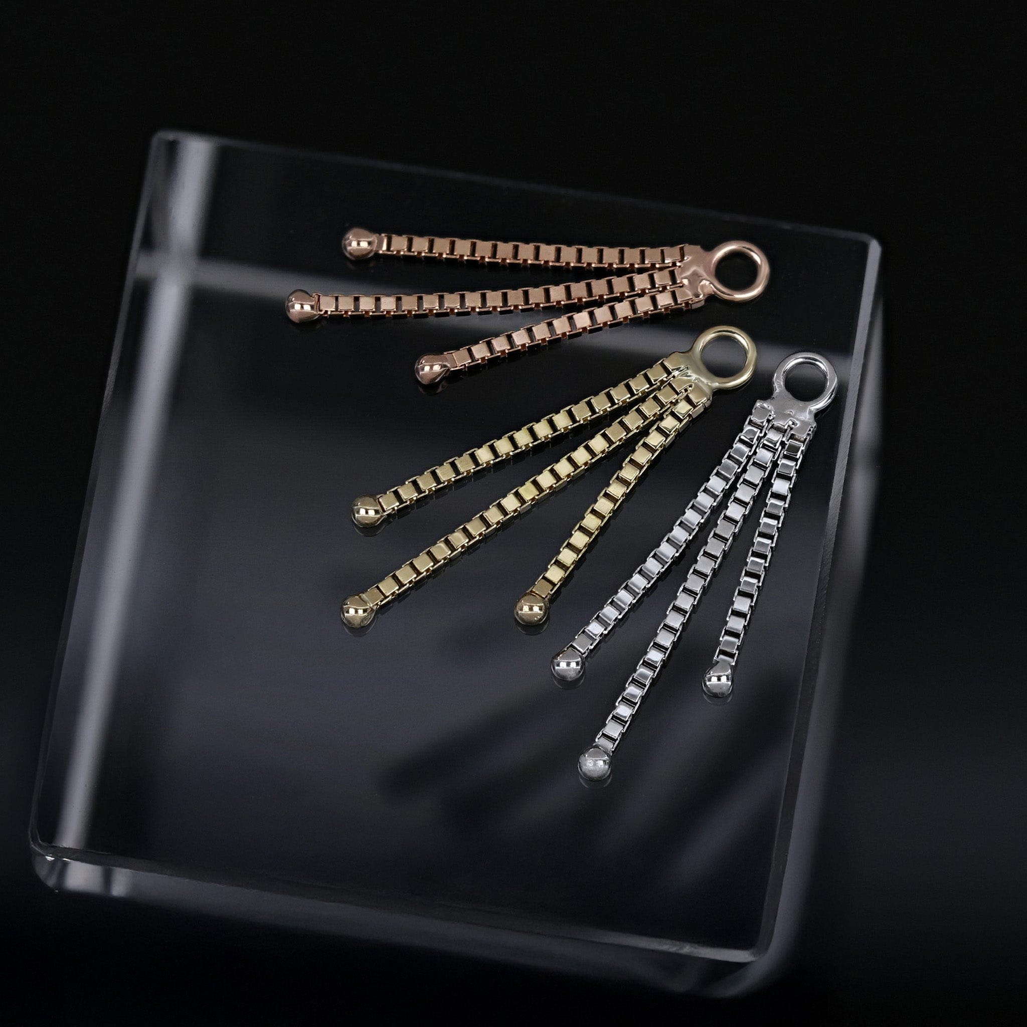 BEATTI 14K solid Gold soma chain charm on black background